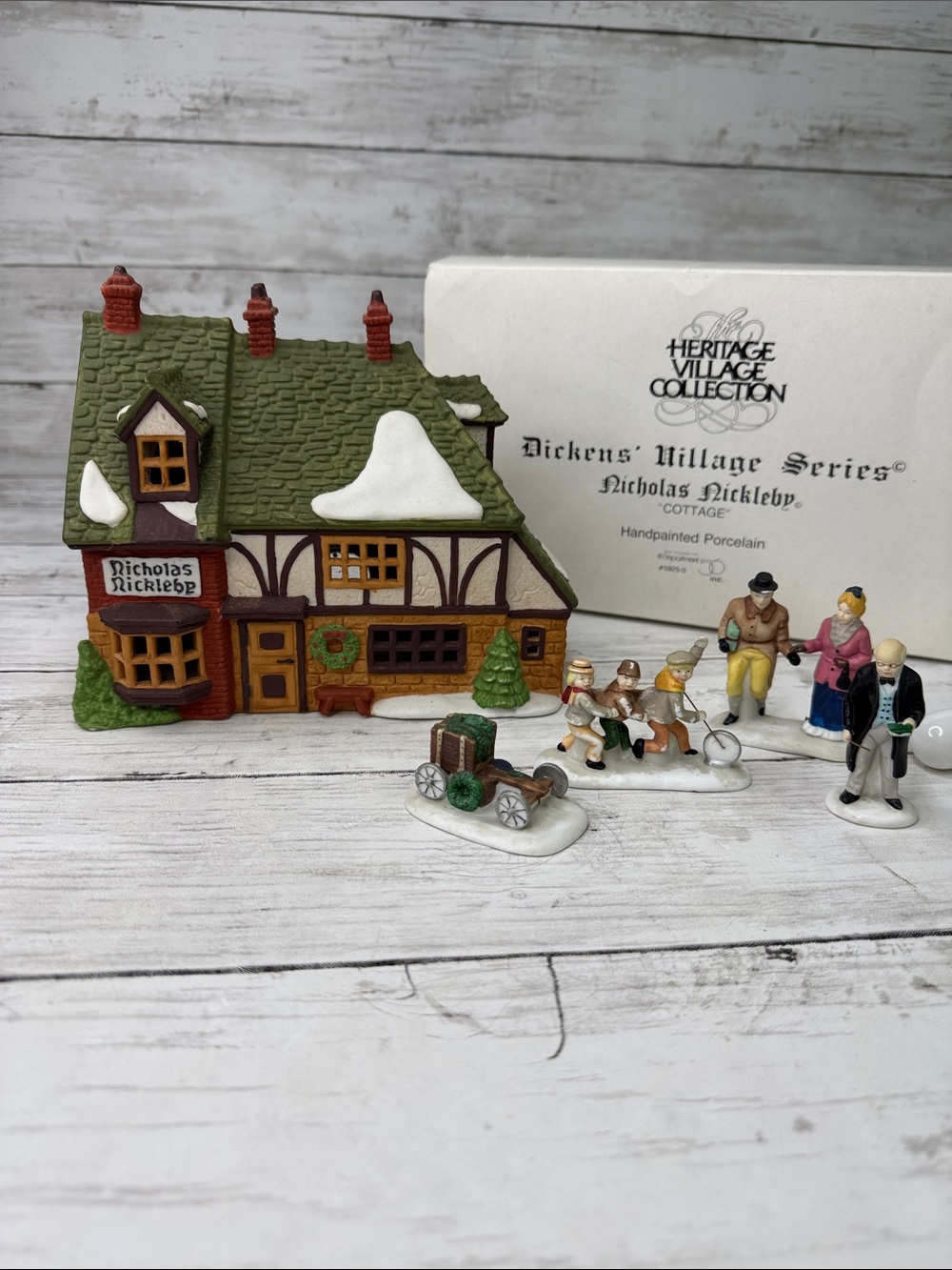 Dept 56 Nicholas Nickleby “Cottage w th box , light and 4 matching figures read